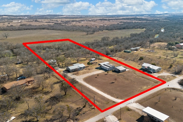 birds eye view of property featuring a rural view