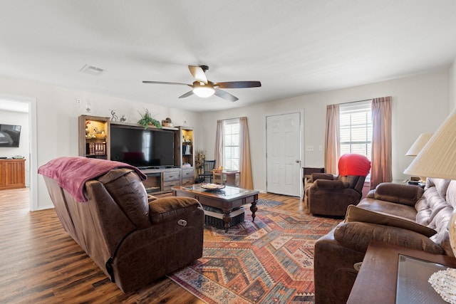 living room featuring ceiling fan and wood-type flooring