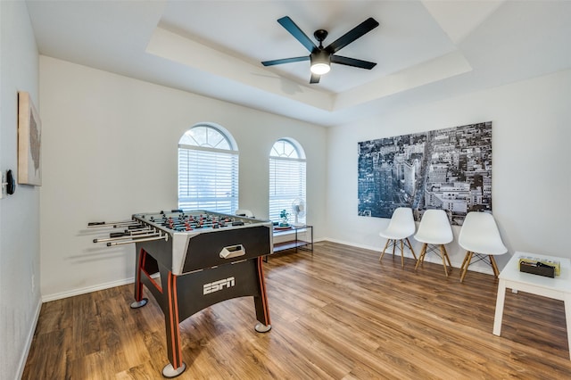 game room featuring ceiling fan, a raised ceiling, and hardwood / wood-style floors