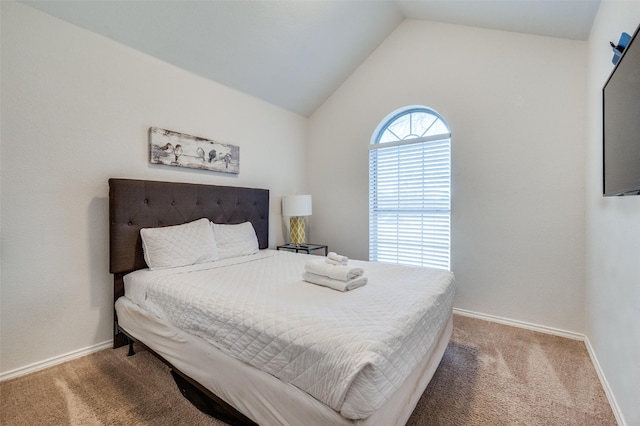 bedroom with vaulted ceiling and carpet flooring