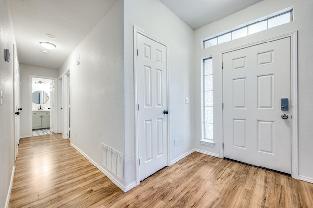 foyer with light hardwood / wood-style floors