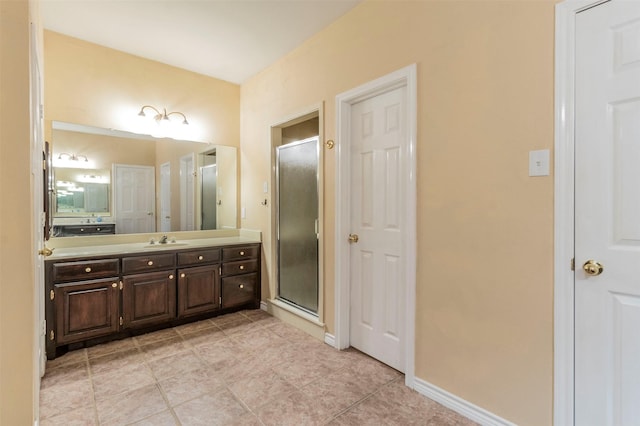 bathroom with a shower with door and vanity