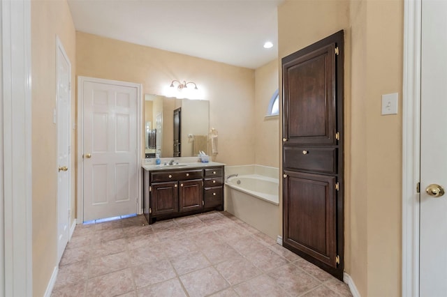 bathroom featuring a tub to relax in and vanity