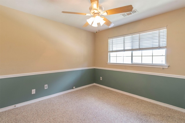 carpeted empty room featuring ceiling fan