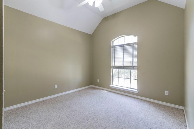 carpeted spare room with vaulted ceiling and ceiling fan