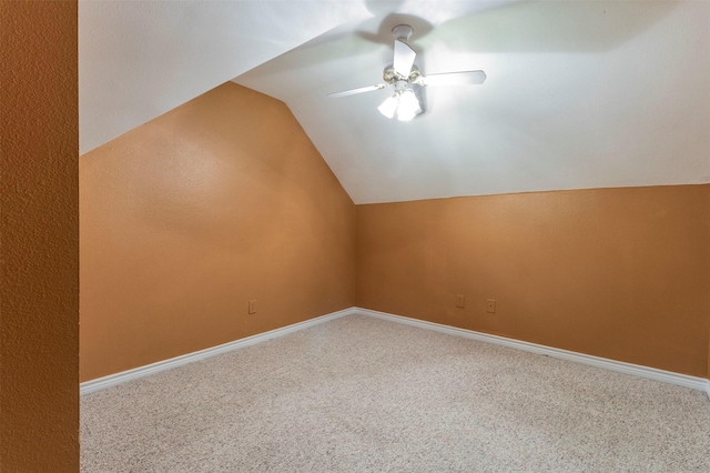 additional living space with carpet floors, vaulted ceiling, and ceiling fan