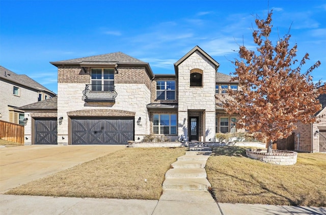 view of front of home with a garage, a balcony, and a front yard