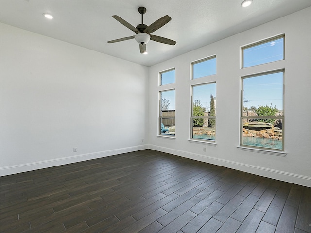 unfurnished room with ceiling fan and dark hardwood / wood-style flooring