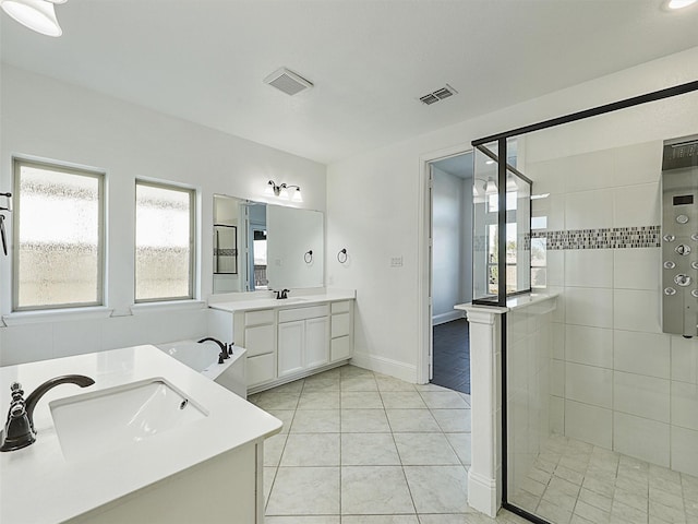 13750 Fernando Rd, Frisco, TX 75035 - bathroom featuring a stall shower, two vanities, tile patterned flooring, and baseboards