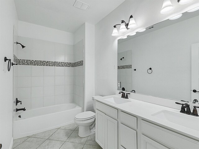 full bathroom featuring tiled shower / bath combo, vanity, tile patterned floors, and toilet