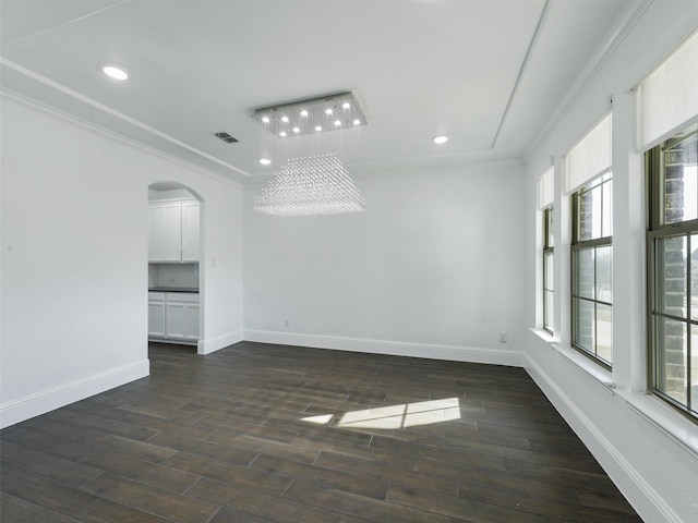 13750 Fernando Rd, Frisco, TX 75035 - empty room with crown molding, healthy amount of natural light, baseboards, arched walkways, and recessed lighting