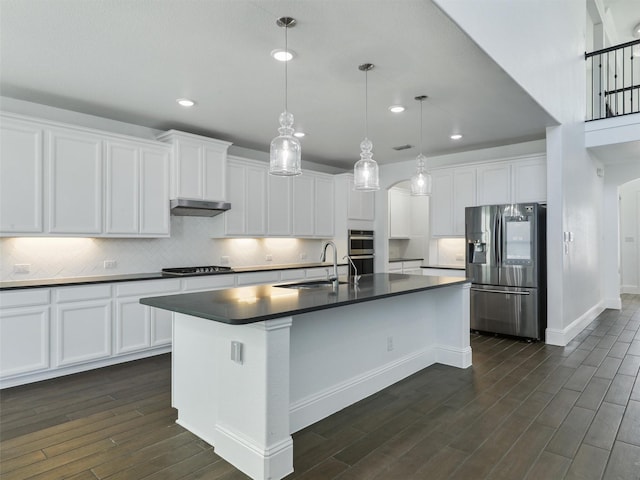 kitchen with sink, white cabinetry, a kitchen island with sink, hanging light fixtures, and stainless steel appliances