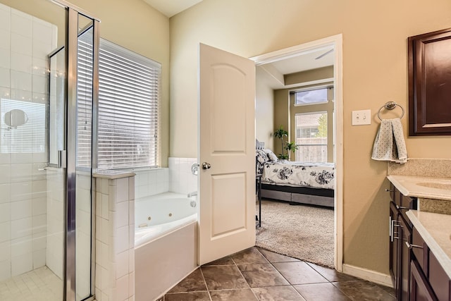 bathroom featuring tile patterned flooring, vanity, and independent shower and bath