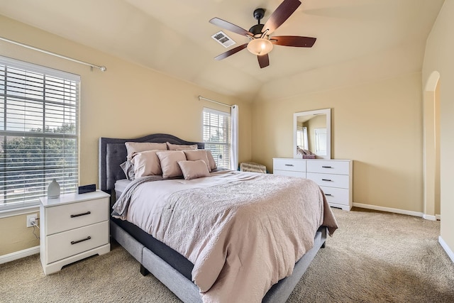 bedroom with light carpet, vaulted ceiling, and ceiling fan