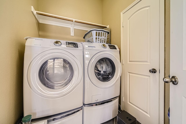 clothes washing area with separate washer and dryer