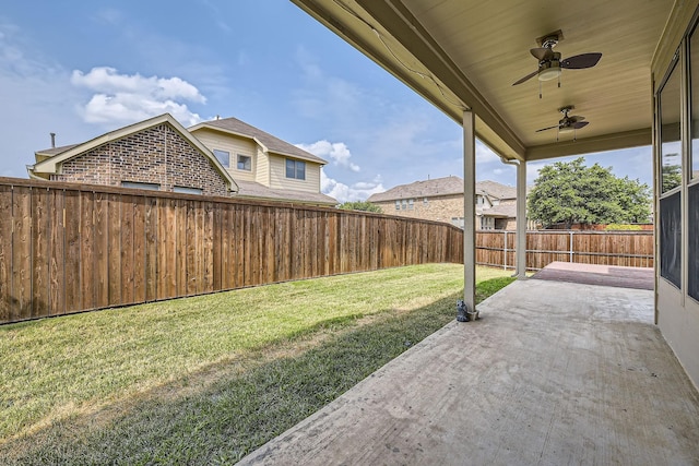 view of yard with a patio area and ceiling fan