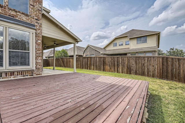 wooden deck with ceiling fan and a yard