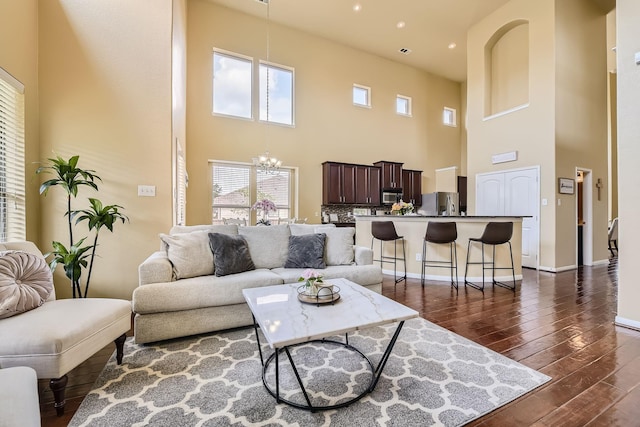 living room with a chandelier and a high ceiling