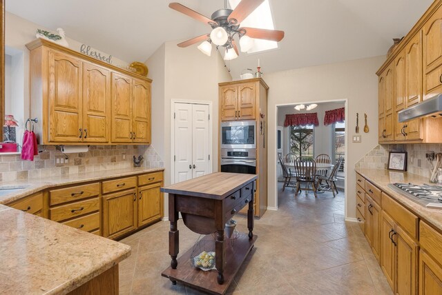 kitchen featuring backsplash, butcher block countertops, ceiling fan, and stainless steel appliances