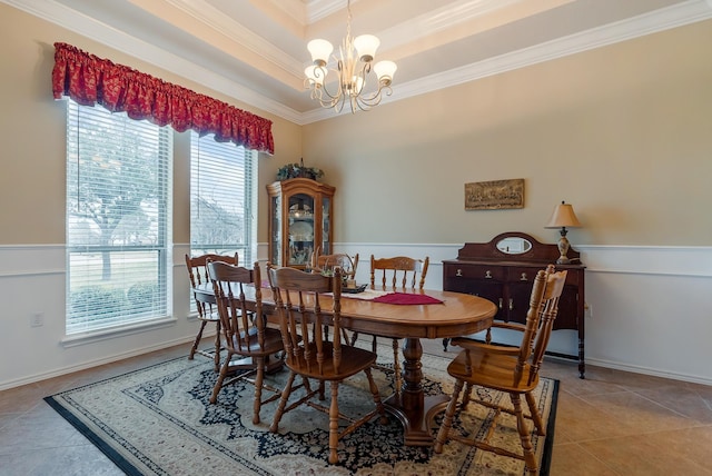 dining room featuring a wealth of natural light, light tile patterned floors, ornamental molding, and a notable chandelier