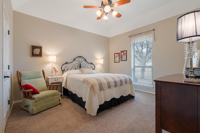 carpeted bedroom with ceiling fan and multiple windows