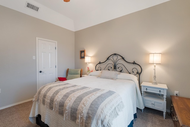 bedroom with lofted ceiling and dark carpet