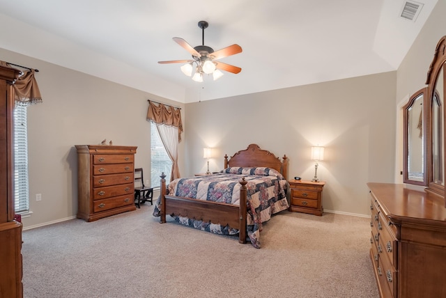 bedroom with vaulted ceiling, light colored carpet, and ceiling fan