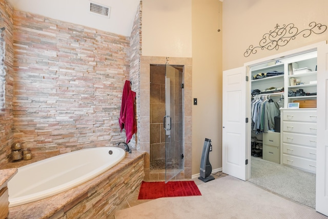 bathroom featuring separate shower and tub