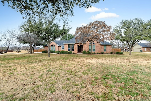 single story home featuring a front lawn