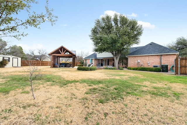 view of yard with a gazebo and a storage unit