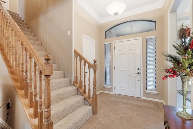 entryway featuring ornamental molding and light tile patterned floors