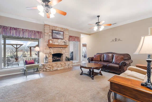 living room with ceiling fan, crown molding, a fireplace, and tile patterned flooring