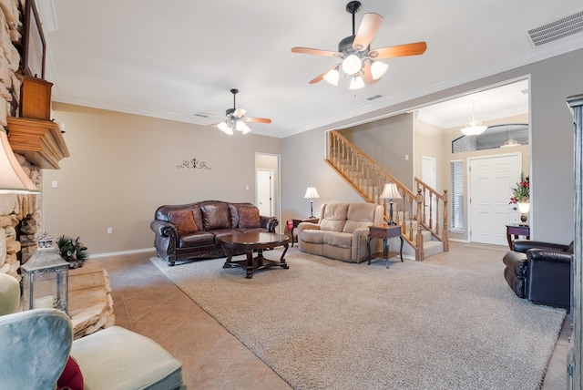 living room featuring crown molding, a fireplace, ceiling fan, and light tile patterned flooring