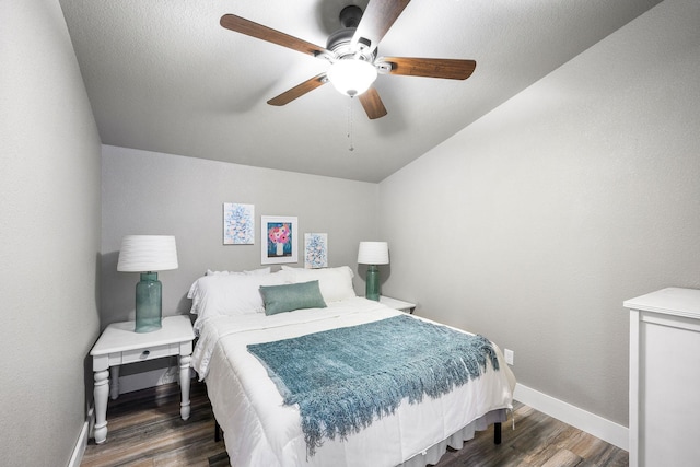 bedroom with ceiling fan and dark hardwood / wood-style floors