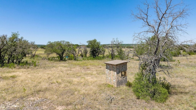 view of yard with a rural view