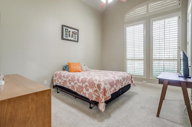 carpeted bedroom featuring ceiling fan and lofted ceiling