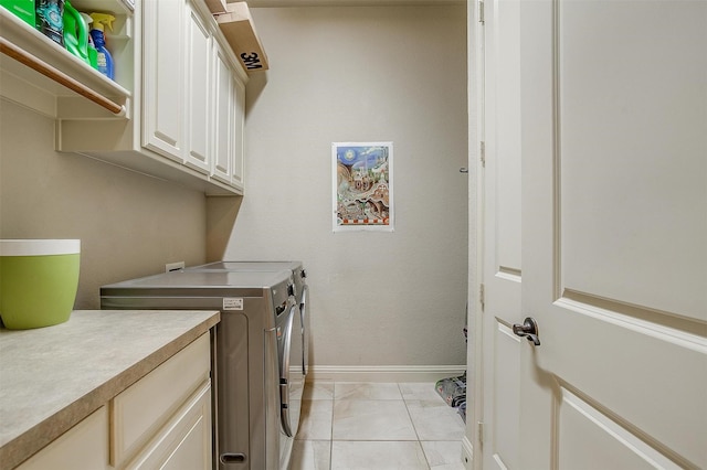 laundry area featuring cabinets and washing machine and clothes dryer