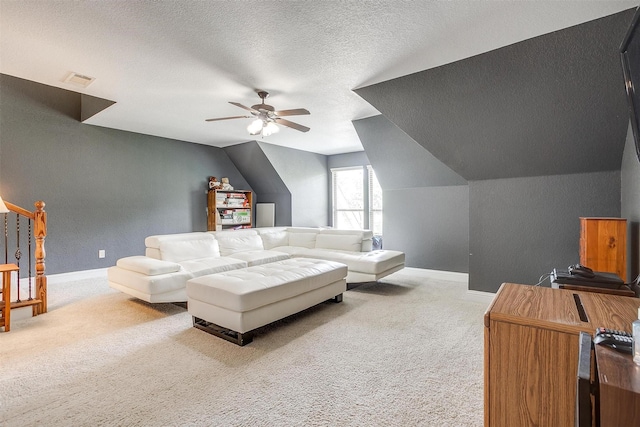 carpeted living room featuring ceiling fan, lofted ceiling, and a textured ceiling