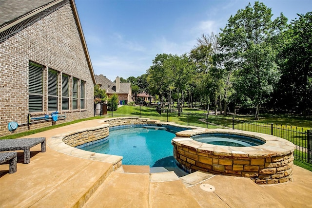 view of swimming pool with an in ground hot tub and a yard