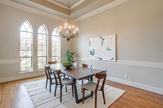 dining space with light hardwood / wood-style flooring, plenty of natural light, and ornamental molding