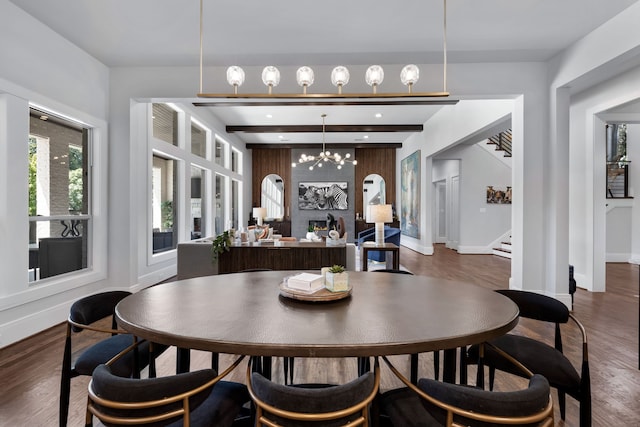 dining space with a chandelier, dark hardwood / wood-style floors, and beam ceiling