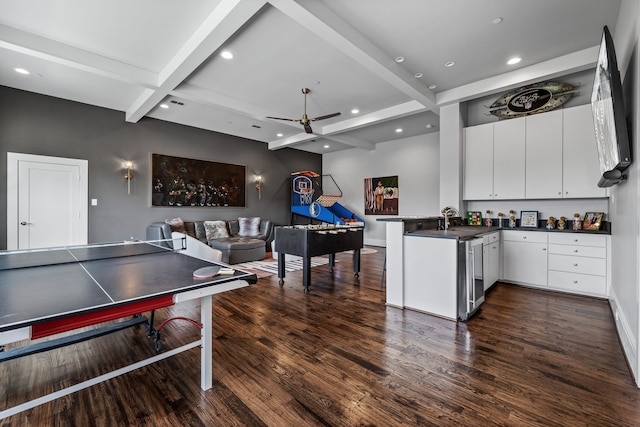 recreation room featuring ceiling fan, sink, dark hardwood / wood-style flooring, and beam ceiling