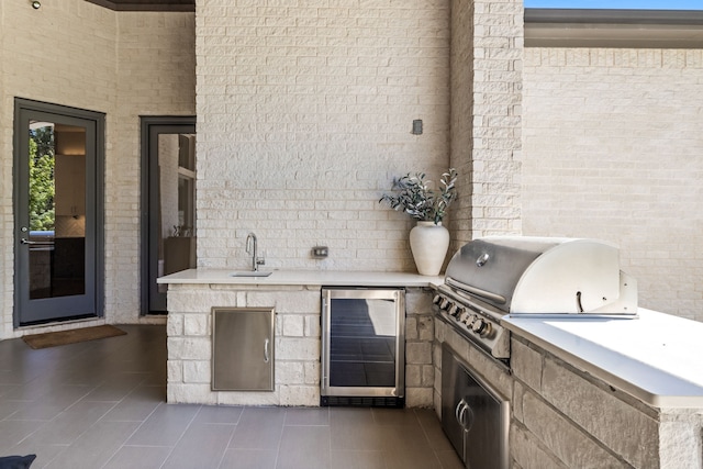 view of patio / terrace featuring sink, an outdoor kitchen, and a grill