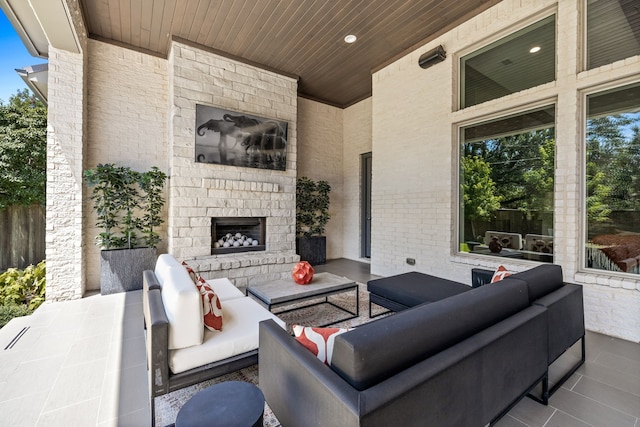 view of patio featuring an outdoor living space with a fireplace