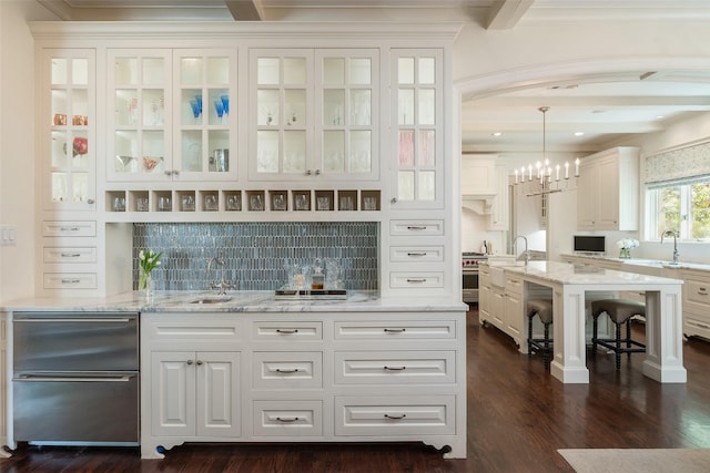 bar with tasteful backsplash, white cabinetry, beam ceiling, pendant lighting, and light stone counters