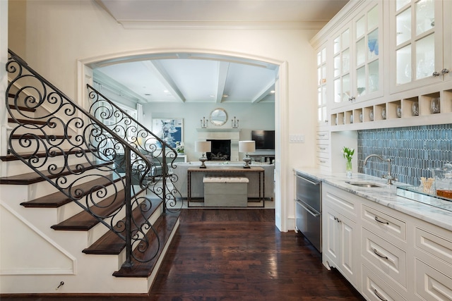 interior space with sink, a healthy amount of sunlight, crown molding, and wood-type flooring