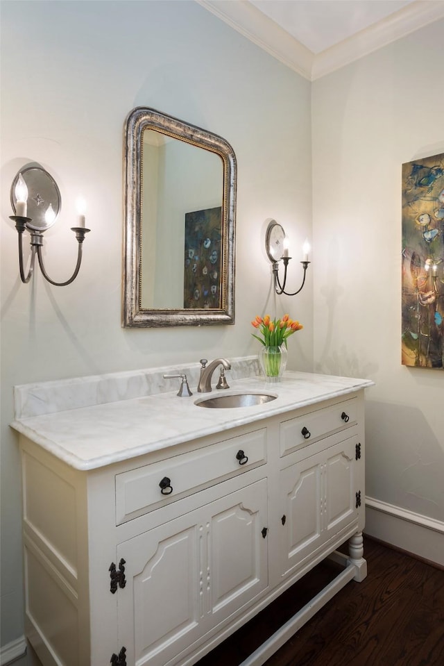 bathroom with ornamental molding, hardwood / wood-style floors, and vanity