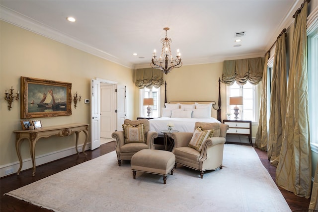 bedroom with dark wood-type flooring, a chandelier, a baseboard heating unit, and ornamental molding