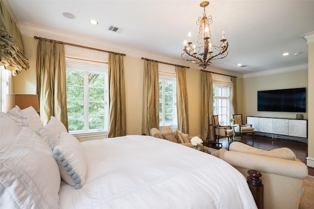 bedroom featuring a notable chandelier, ornamental molding, and hardwood / wood-style floors