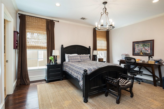 bedroom featuring crown molding, dark wood-type flooring, and a notable chandelier